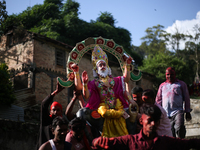 Devotees take the idol of Lord Vishwokarma to immerse it in a river on the outskirts of Kathmandu, Nepal, on September 18, 2024. Vishwokarma...