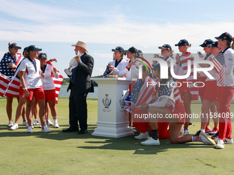 GAINESVILLE, VIRGINIA - SEPTEMBER 15: Members of Team USA look on as John Solheim, representing the Solheim family, presents the trophy to C...