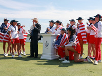 GAINESVILLE, VIRGINIA - SEPTEMBER 15: Members of Team USA look on as John Solheim, representing the Solheim family, presents the trophy to C...