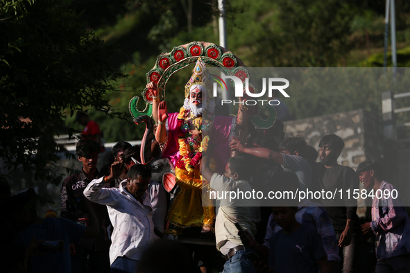 Devotees take the idol of Lord Vishwokarma to immerse it in a river on the outskirts of Kathmandu, Nepal, on September 18, 2024. Vishwokarma...