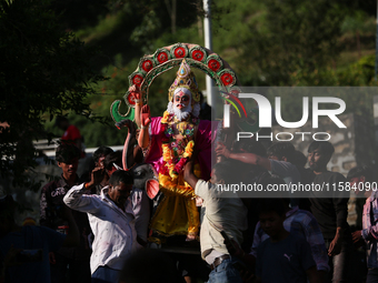 Devotees take the idol of Lord Vishwokarma to immerse it in a river on the outskirts of Kathmandu, Nepal, on September 18, 2024. Vishwokarma...