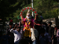 Devotees take the idol of Lord Vishwokarma to immerse it in a river on the outskirts of Kathmandu, Nepal, on September 18, 2024. Vishwokarma...