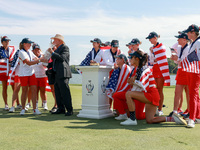 GAINESVILLE, VIRGINIA - SEPTEMBER 15: Members of Team USA look on as John Solheim, representing the Solheim family, presents the trophy to C...