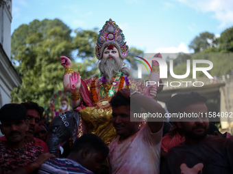 Devotees take the idol of Lord Vishwokarma to immerse it in a river on the outskirts of Kathmandu, Nepal, on September 18, 2024. Vishwokarma...