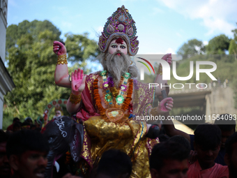 Devotees take the idol of Lord Vishwokarma to immerse it in a river on the outskirts of Kathmandu, Nepal, on September 18, 2024. Vishwokarma...