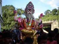 Devotees take the idol of Lord Vishwokarma to immerse it in a river on the outskirts of Kathmandu, Nepal, on September 18, 2024. Vishwokarma...