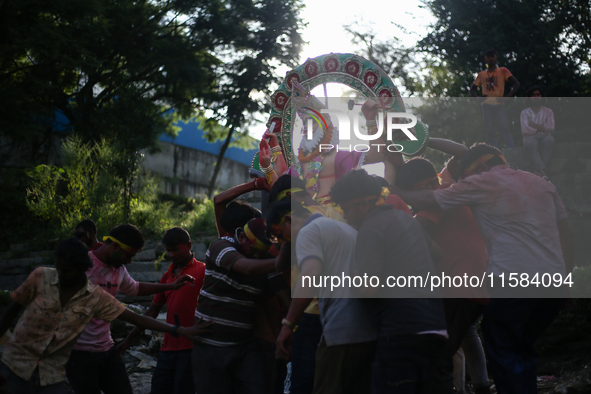 Devotees take the idol of Lord Vishwokarma to immerse it in a river on the outskirts of Kathmandu, Nepal, on September 18, 2024. Vishwokarma...