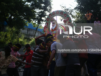 Devotees take the idol of Lord Vishwokarma to immerse it in a river on the outskirts of Kathmandu, Nepal, on September 18, 2024. Vishwokarma...