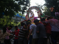 Devotees take the idol of Lord Vishwokarma to immerse it in a river on the outskirts of Kathmandu, Nepal, on September 18, 2024. Vishwokarma...