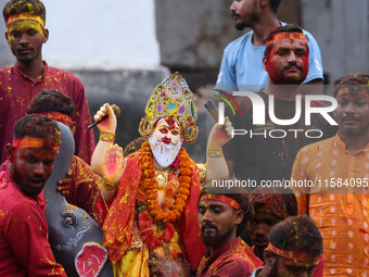 Devotees take the idol of Lord Vishwokarma to immerse it in a river on the outskirts of Kathmandu, Nepal, on September 18, 2024. Vishwokarma...