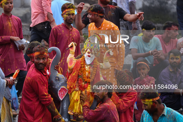 Devotees take the idol of Lord Vishwokarma to immerse it in a river on the outskirts of Kathmandu, Nepal, on September 18, 2024. Vishwokarma...