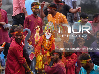 Devotees take the idol of Lord Vishwokarma to immerse it in a river on the outskirts of Kathmandu, Nepal, on September 18, 2024. Vishwokarma...