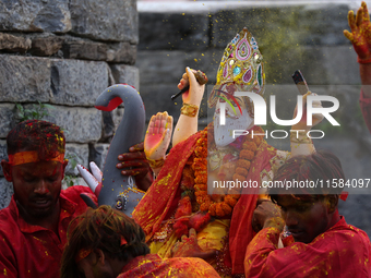 Devotees take the idol of Lord Vishwokarma to immerse it in a river on the outskirts of Kathmandu, Nepal, on September 18, 2024. Vishwokarma...