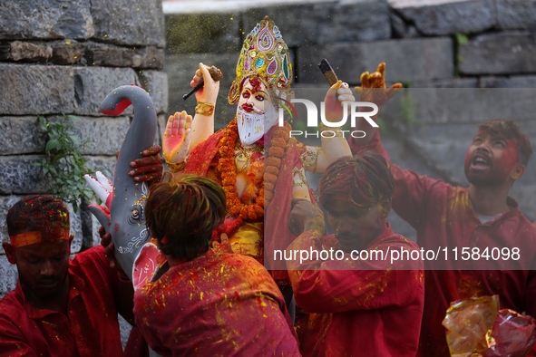 Devotees take the idol of Lord Vishwokarma to immerse it in a river on the outskirts of Kathmandu, Nepal, on September 18, 2024. Vishwokarma...