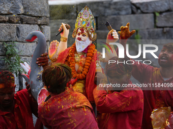 Devotees take the idol of Lord Vishwokarma to immerse it in a river on the outskirts of Kathmandu, Nepal, on September 18, 2024. Vishwokarma...