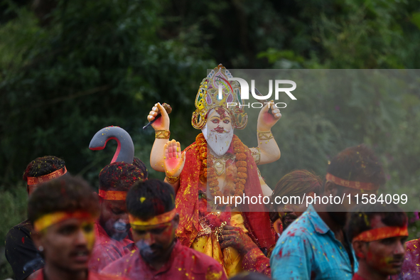 Devotees take the idol of Lord Vishwokarma to immerse it in a river on the outskirts of Kathmandu, Nepal, on September 18, 2024. Vishwokarma...