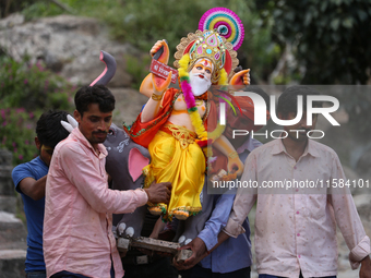 Devotees take the idol of Lord Vishwokarma to immerse it in a river on the outskirts of Kathmandu, Nepal, on September 18, 2024. Vishwokarma...