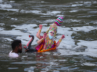 Hindu devotees immerse the idol of Vishwakarma, the god of machines and metallurgy, in the Bagmati River on the outskirts of Kathmandu, Nepa...