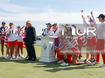 GAINESVILLE, VIRGINIA - SEPTEMBER 15: Members of Team USA look on after John Solheim, representing the Solheim family, presented the trophy...