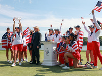 GAINESVILLE, VIRGINIA - SEPTEMBER 15: Members of Team USA look as Captain Stacy Lewis hoists the trophy  after John Solheim, representing th...