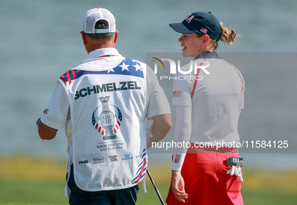 GAINESVILLE, VIRGINIA - SEPTEMBER 15: Sarah Schmelzel of the United States walks with her caddie on the 18th green after a Team USA win at t...