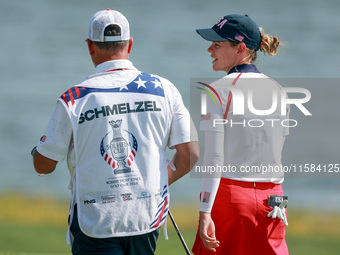 GAINESVILLE, VIRGINIA - SEPTEMBER 15: Sarah Schmelzel of the United States walks with her caddie on the 18th green after a Team USA win at t...