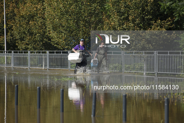 People carry pet transporters and look for stray cats as they prepare for the flood wave to reach Wroclaw, Poland, on September 18, 2024. Th...