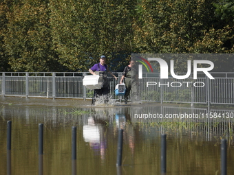 People carry pet transporters and look for stray cats as they prepare for the flood wave to reach Wroclaw, Poland, on September 18, 2024. Th...