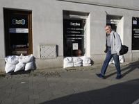 A man walks past closed shops protected by sandbags in Wroclaw, Poland, on September 18, 2024. The government outlines a reconstruction plan...