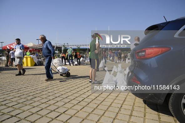 People carry sandbags as they prepare for the flood wave to reach Wroclaw, Poland, on September 18, 2024. The government outlines a reconstr...