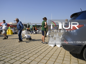 People carry sandbags as they prepare for the flood wave to reach Wroclaw, Poland, on September 18, 2024. The government outlines a reconstr...