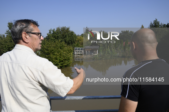 People look at submerged social gardens on the outskirts of Wroclaw as they prepare for the flood wave to reach the southwestern city of Wro...