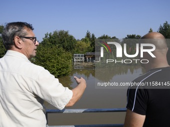 People look at submerged social gardens on the outskirts of Wroclaw as they prepare for the flood wave to reach the southwestern city of Wro...