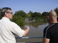 People look at submerged social gardens on the outskirts of Wroclaw as they prepare for the flood wave to reach the southwestern city of Wro...