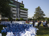 People and members of the territorial defense army fill bags with sand as they prepare for the flood wave to reach the southwestern city of...