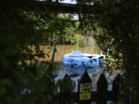 An inflatable swimming pool drifts as floodwaters reach the social gardens on the outskirts of Wroclaw, Poland, on September 18, 2024. The g...