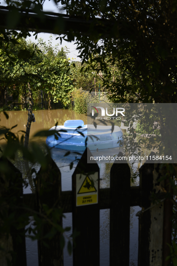 An inflatable swimming pool drifts as floodwaters reach the social gardens on the outskirts of Wroclaw, Poland, on September 18, 2024. The g...