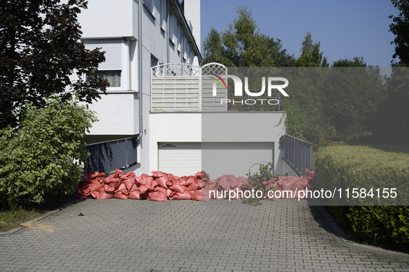 Sandbags are seen outside a house garage as people prepare for the flood wave to reach Wroclaw, Poland, on September 18, 2024. The governmen...