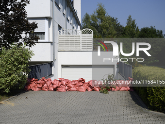 Sandbags are seen outside a house garage as people prepare for the flood wave to reach Wroclaw, Poland, on September 18, 2024. The governmen...