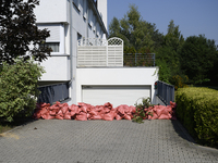 Sandbags are seen outside a house garage as people prepare for the flood wave to reach Wroclaw, Poland, on September 18, 2024. The governmen...