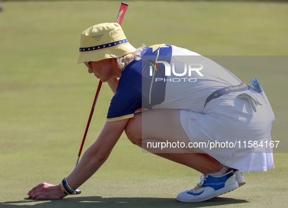 GAINESVILLE, VIRGINIA - SEPTEMBER 15: Madelene Sagstrom of Team Europe places her ball on the 18th green at the conclusion of the Solheim Cu...