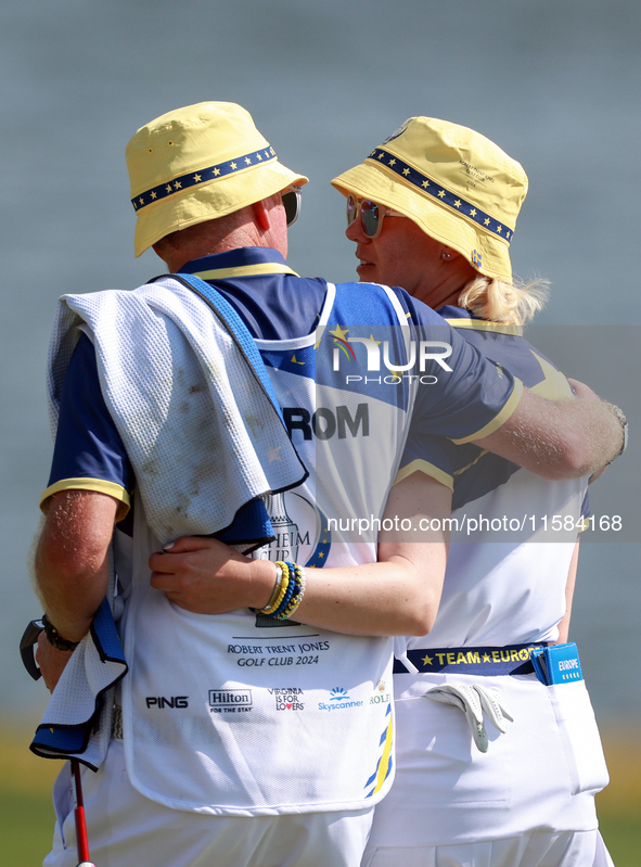 GAINESVILLE, VIRGINIA - SEPTEMBER 15: Madelene Sagstrom of Team Europe walks with her caddie on the 18th green at the conclusion of the Solh...