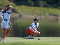 GAINESVILLE, VIRGINIA - SEPTEMBER 15: Jennifer Kupcho of the United States lines up her putt on the 11th green as Linn Grant of Team Europe...