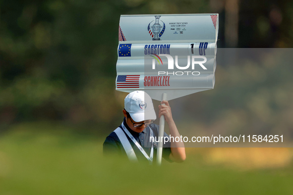 GAINESVILLE, VIRGINIA - SEPTEMBER 15: The standard bearer carries the sign displaying the score for Madelene Sagstrom of Team Europe versus...