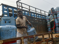 Laborers unload filled gas cylinders from a truck in Dhaka, Bangladesh, on September 18, 2024. (