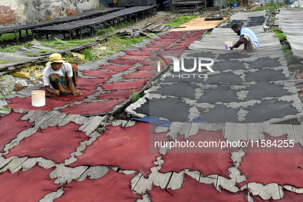 Workers set wet leather at a tannery in Dhaka, Bangladesh, on September 18, 2024. 