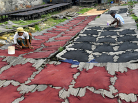 Workers set wet leather at a tannery in Dhaka, Bangladesh, on September 18, 2024. (