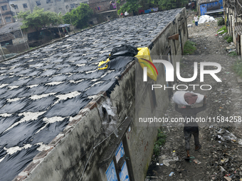 A worker carries leather at a tannery in the Hazaribagh area of Dhaka, Bangladesh, on September 18, 2024. (