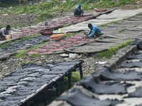 Workers set wet leather at a tannery in Dhaka, Bangladesh, on September 18, 2024. (