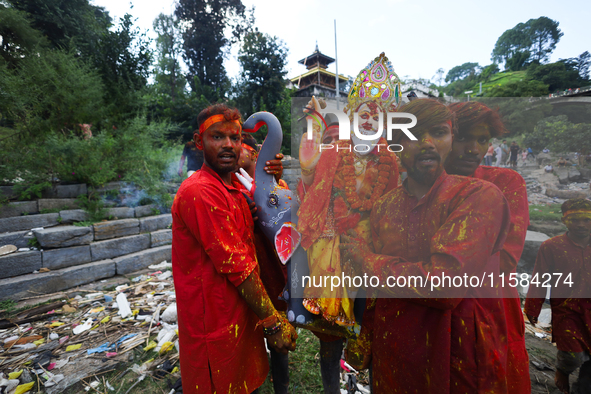 Nepali Hindu devotees carry an eco-friendly idol of Lord Bishwokarma to immerse it in the Bagmati River in Kathmandu, Nepal, on September 18...